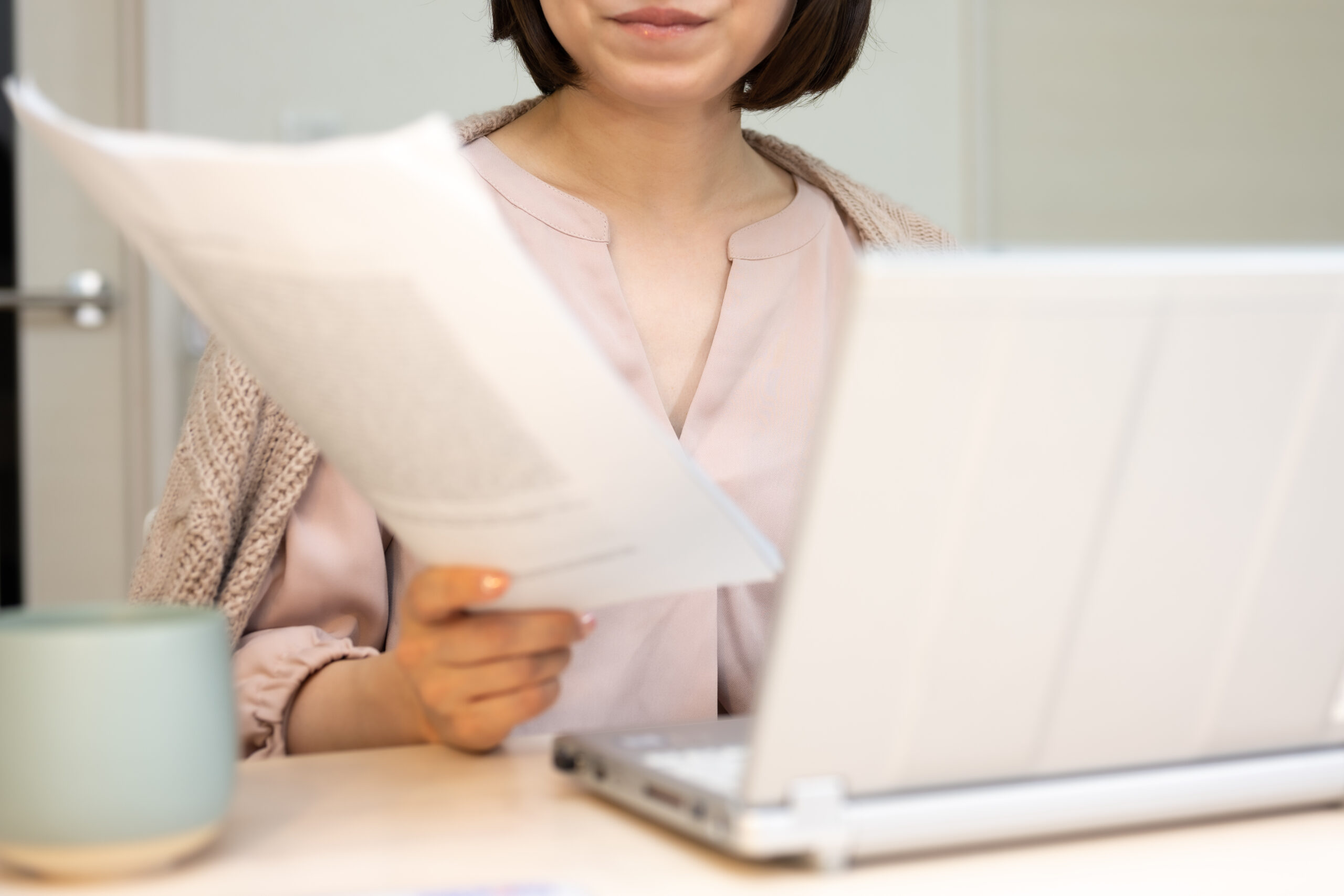 在宅勤務で書類をチェックする女性